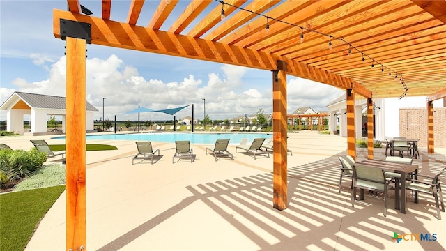 view of patio / terrace with a community pool and a pergola
