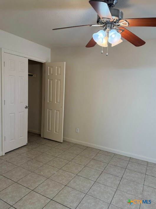 unfurnished bedroom featuring light tile patterned floors and ceiling fan