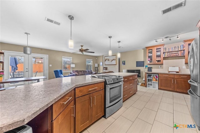 kitchen with decorative light fixtures, backsplash, french doors, and stainless steel appliances