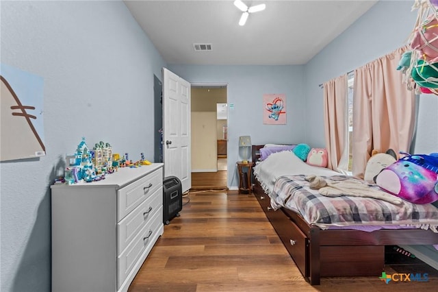 bedroom with dark wood-type flooring