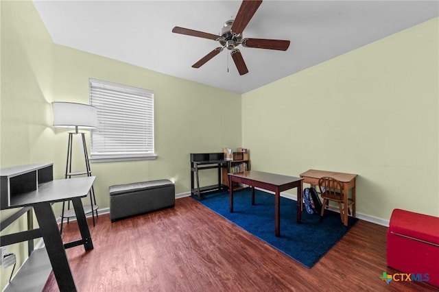 living area with ceiling fan and dark hardwood / wood-style flooring