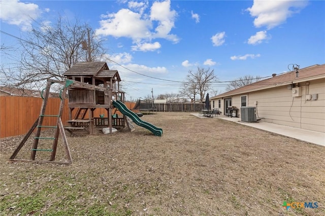 view of jungle gym with a patio, central AC unit, and a lawn