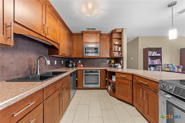 kitchen featuring decorative backsplash, sink, pendant lighting, and stainless steel appliances