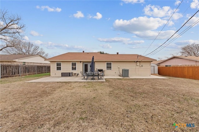 rear view of house with a patio area, a lawn, and central air condition unit