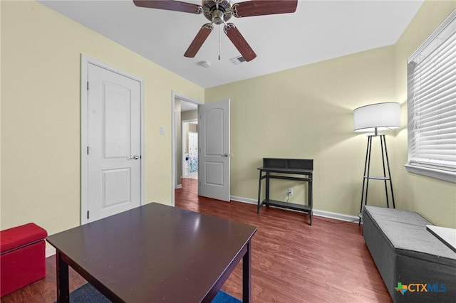 office space with dark wood-type flooring and ceiling fan