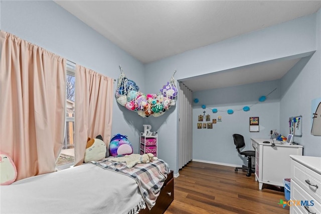 bedroom with dark hardwood / wood-style flooring