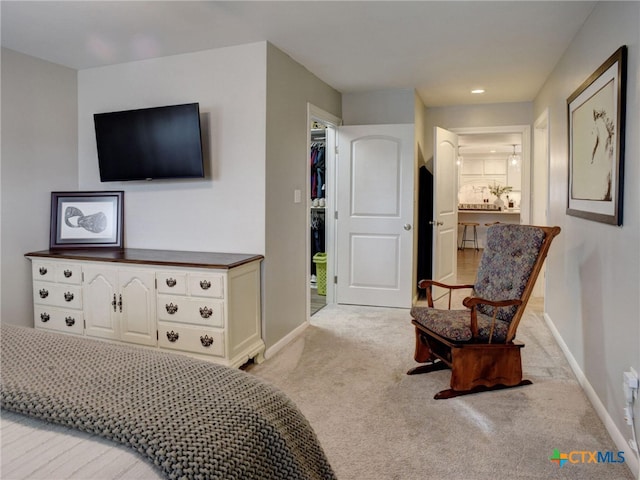 bedroom with baseboards and light colored carpet