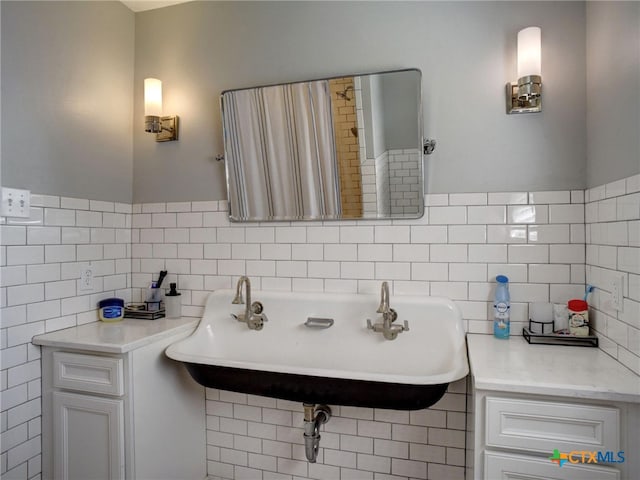 bathroom with backsplash, tile walls, and a sink
