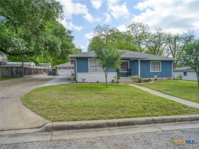 view of front of home featuring covered porch, driveway, a front yard, and fence