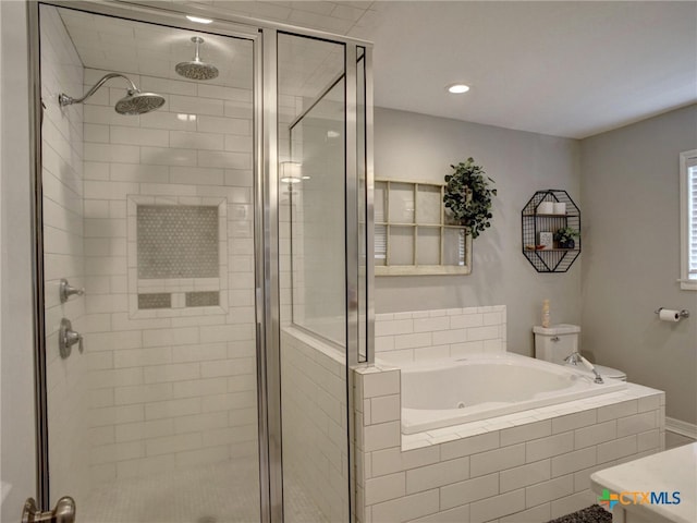 bathroom featuring recessed lighting, a stall shower, and a jetted tub