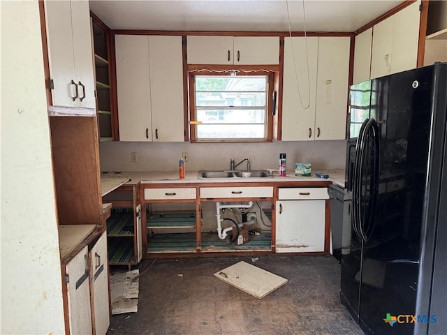 102 E Victory Ave, Temple, TX 76501 - kitchen with freestanding refrigerator, open shelves, a sink, and light countertops