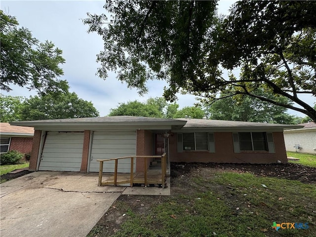 102 E Victory Ave, Temple, TX 76501 - ranch-style home featuring concrete driveway, brick siding, and an attached garage