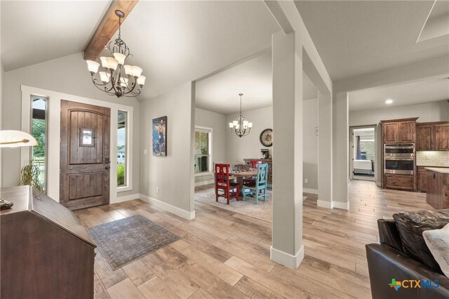 entryway featuring an inviting chandelier, recessed lighting, baseboards, vaulted ceiling with beams, and light wood-type flooring