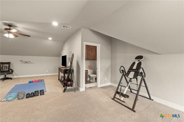 workout room with visible vents, carpet flooring, ceiling fan, and lofted ceiling