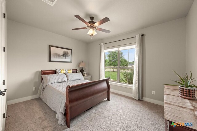 bedroom featuring visible vents, baseboards, and light colored carpet