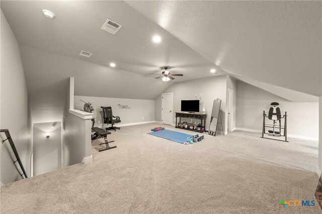 workout room featuring visible vents, carpet floors, lofted ceiling, and ceiling fan