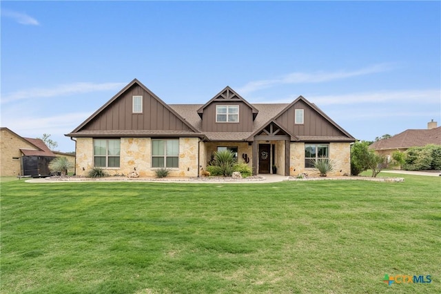 craftsman-style home featuring board and batten siding, a front yard, and stone siding
