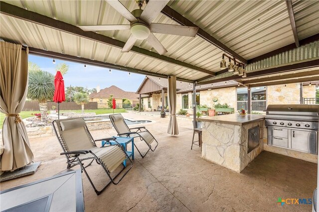 view of patio / terrace featuring a grill, area for grilling, a fenced in pool, a ceiling fan, and outdoor wet bar
