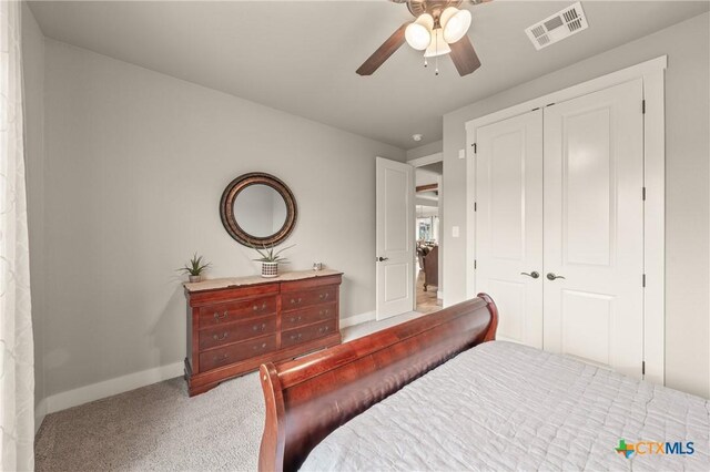 bedroom with visible vents, carpet flooring, baseboards, and a closet
