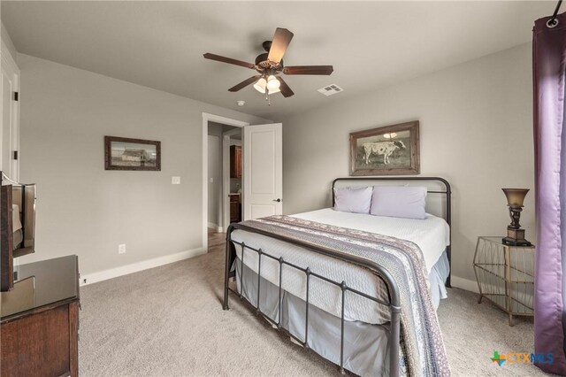 carpeted bedroom featuring baseboards, ceiling fan, and visible vents