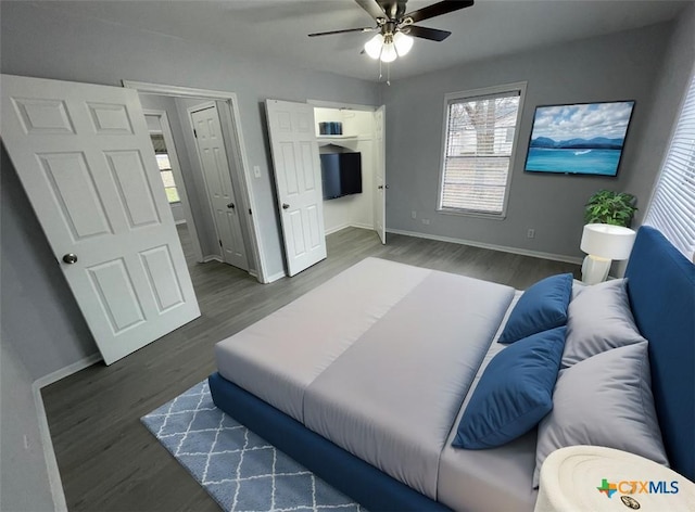 bedroom with wood finished floors, a ceiling fan, and baseboards