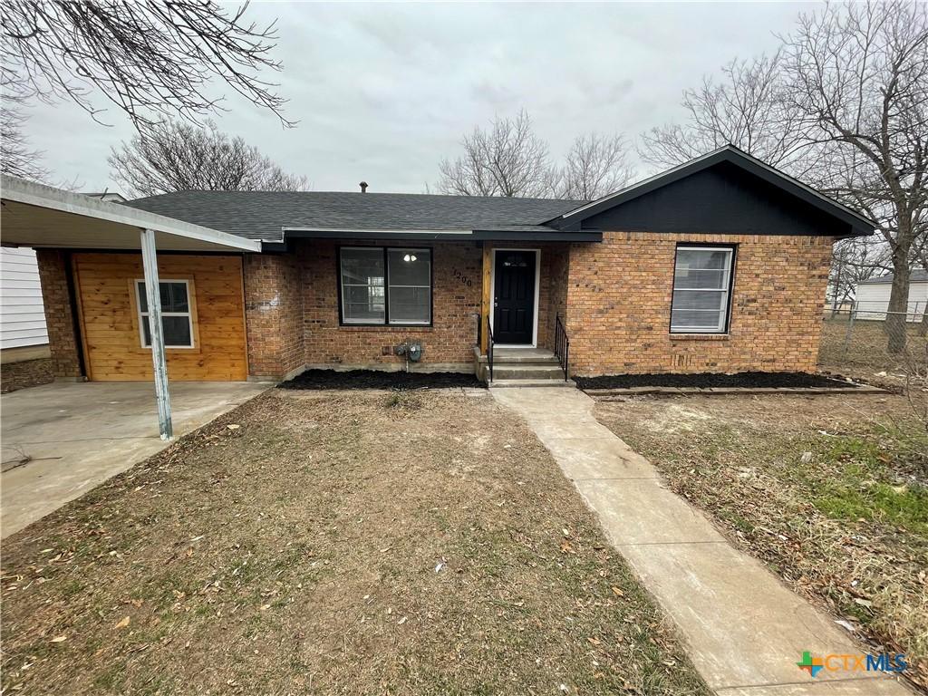 single story home featuring a carport