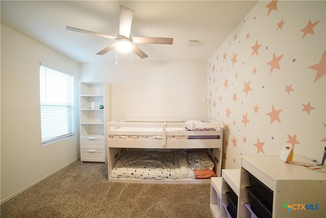 carpeted bedroom featuring wallpapered walls and ceiling fan