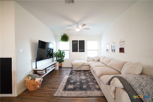 living area with a ceiling fan, visible vents, baseboards, lofted ceiling, and dark wood-type flooring