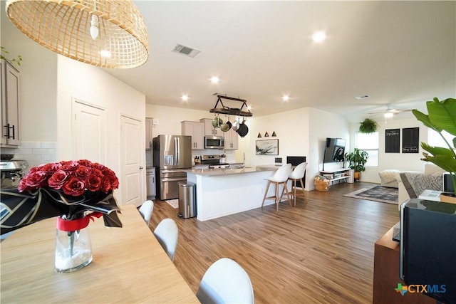 dining room with visible vents, recessed lighting, a ceiling fan, and wood finished floors