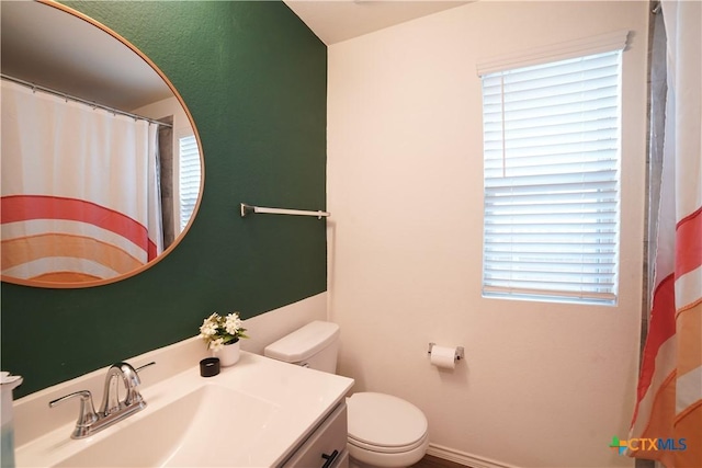 bathroom with vanity, toilet, and a shower with curtain