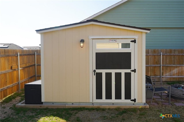 view of shed with a fenced backyard