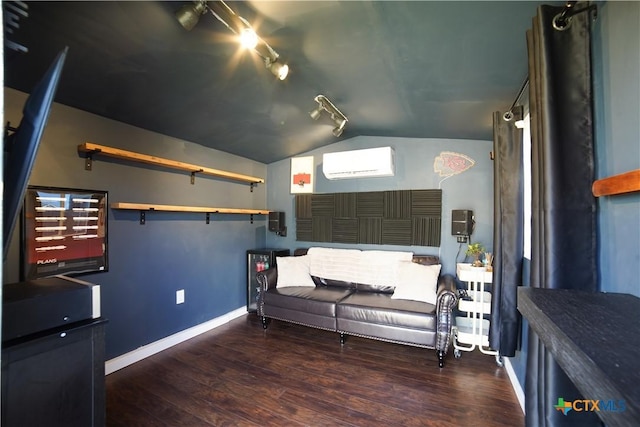 living area with vaulted ceiling, a wall mounted air conditioner, baseboards, and wood finished floors