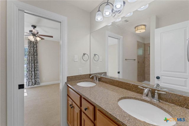 781 Meridian Dr, New Braunfels, TX 78132 - full bath featuring double vanity, a ceiling fan, a shower, and baseboards