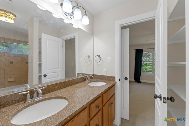 bathroom featuring vanity and tiled shower