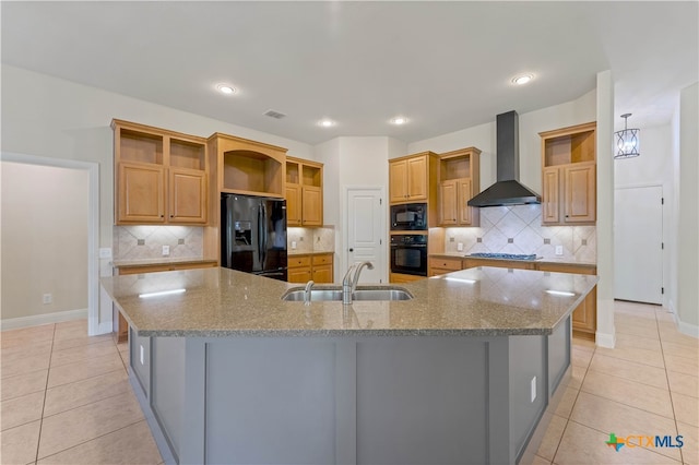 kitchen with sink, black appliances, tasteful backsplash, a spacious island, and wall chimney range hood