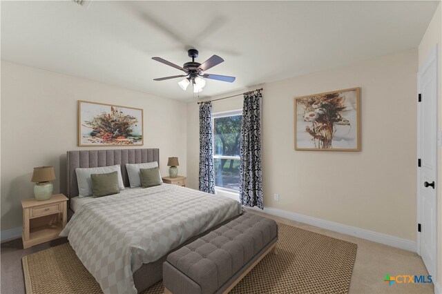 bedroom featuring light colored carpet and ceiling fan