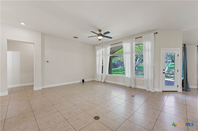 empty room featuring light tile patterned flooring and ceiling fan