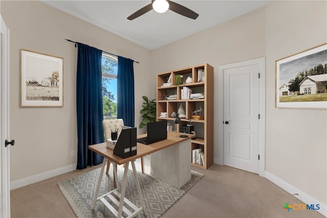 carpeted office featuring ceiling fan