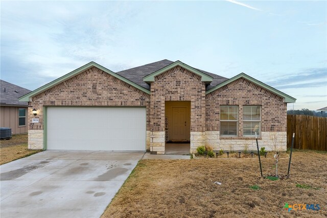 view of front of home with a front yard and a garage