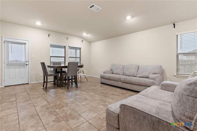 tiled living room with vaulted ceiling