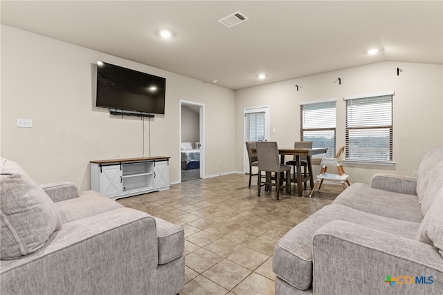 living room with lofted ceiling and light tile patterned flooring