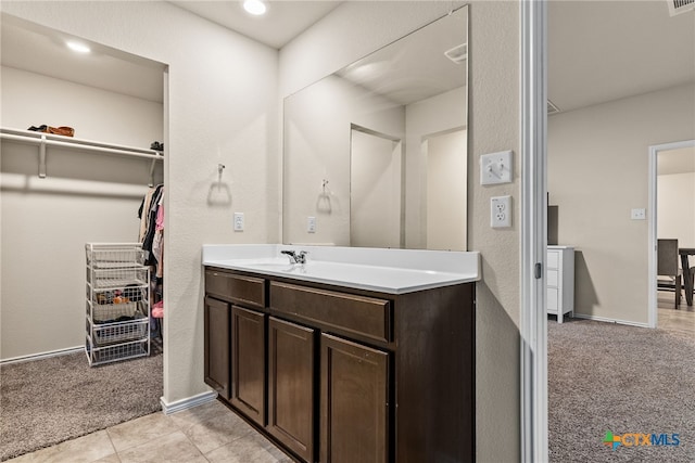 bathroom with tile patterned flooring and vanity