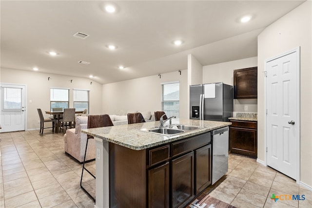 kitchen with stainless steel appliances, an island with sink, sink, and a wealth of natural light