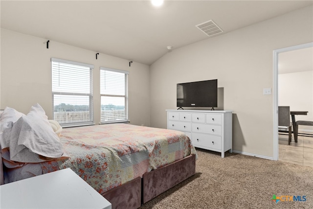 bedroom featuring lofted ceiling and carpet floors