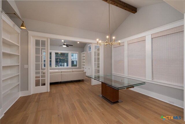645 Center Grn, New Braunfels, TX 78130 - unfurnished dining area with built in shelves, lofted ceiling with beams, ceiling fan with notable chandelier, and wood finished floors
