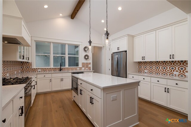 645 Center Grn, New Braunfels, TX 78130 - kitchen with appliances with stainless steel finishes, vaulted ceiling with beams, and tasteful backsplash