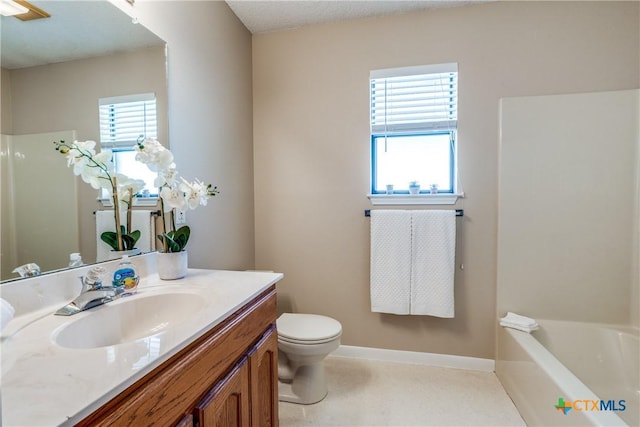 bathroom featuring vanity, a tub to relax in, baseboards, a shower, and toilet