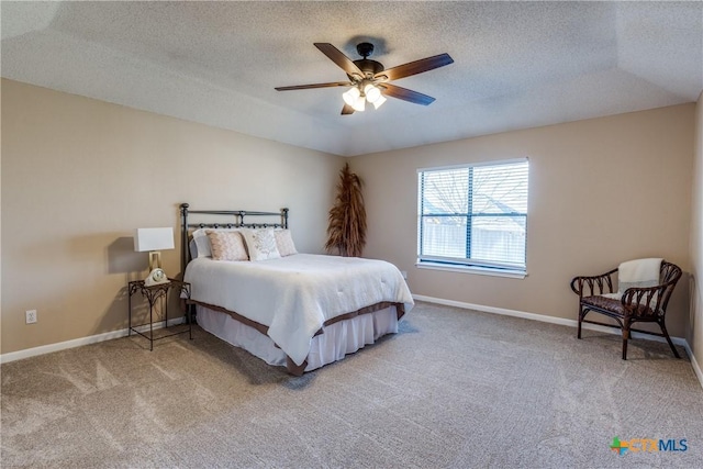 carpeted bedroom with baseboards, a textured ceiling, and ceiling fan