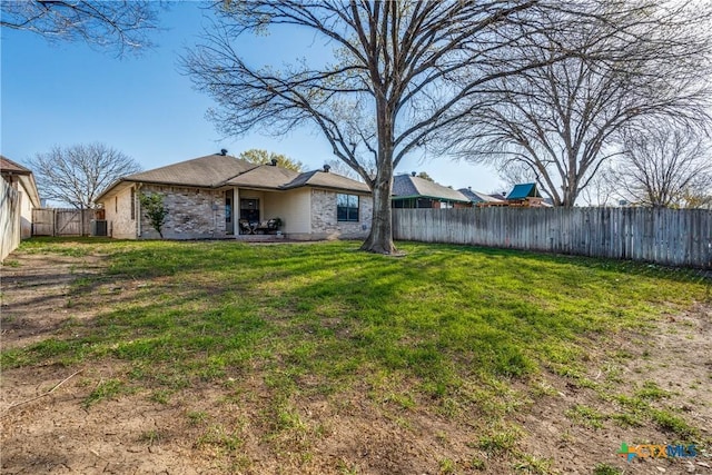 view of yard featuring central air condition unit and a fenced backyard