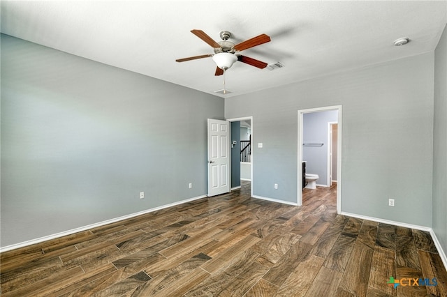 unfurnished bedroom with a spacious closet, dark hardwood / wood-style floors, ceiling fan, and connected bathroom